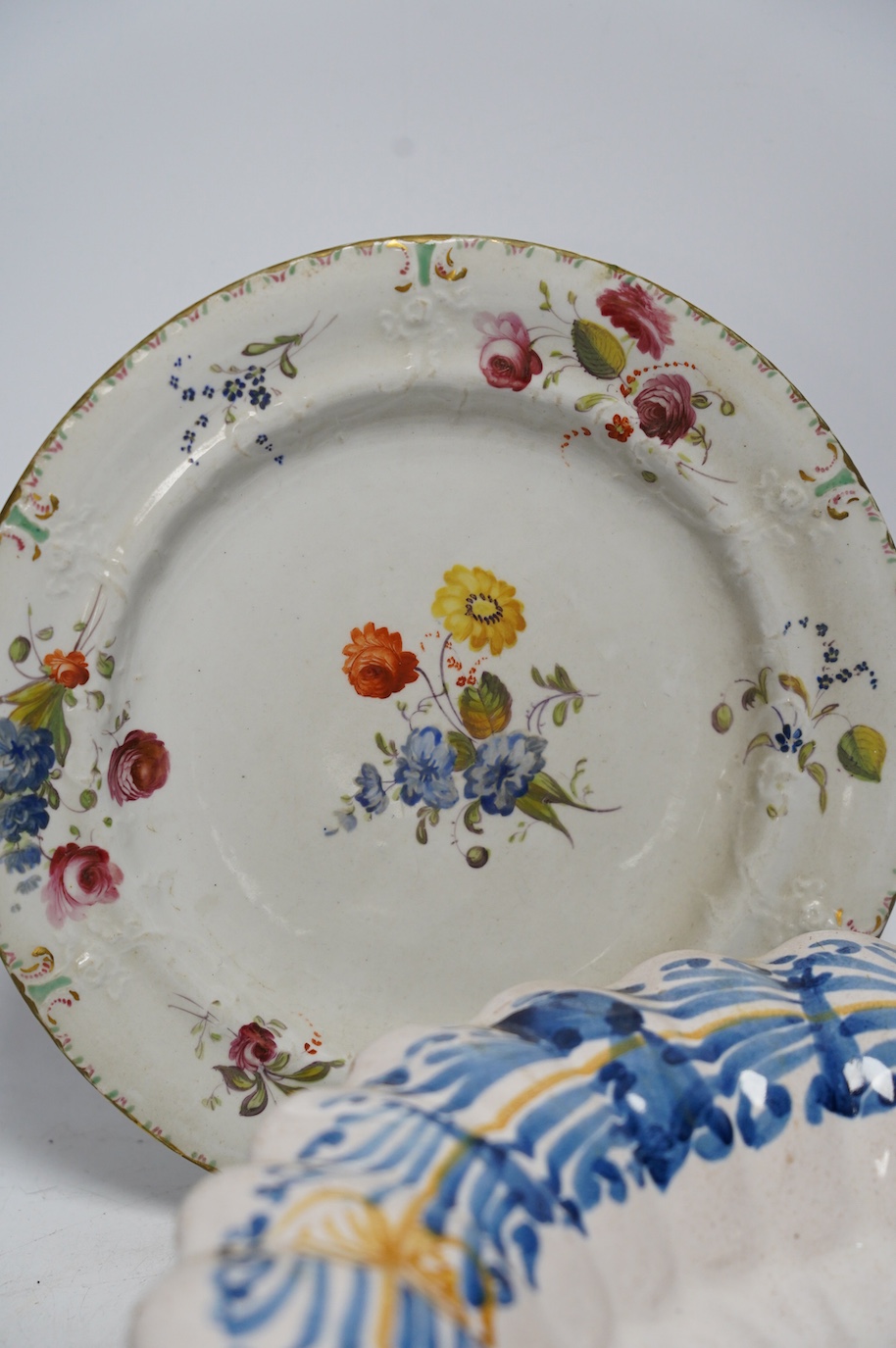 An Italian maiolica dish and a Masons Ironstone floral plate, largest 30cm in diameter (2). Condition - fair